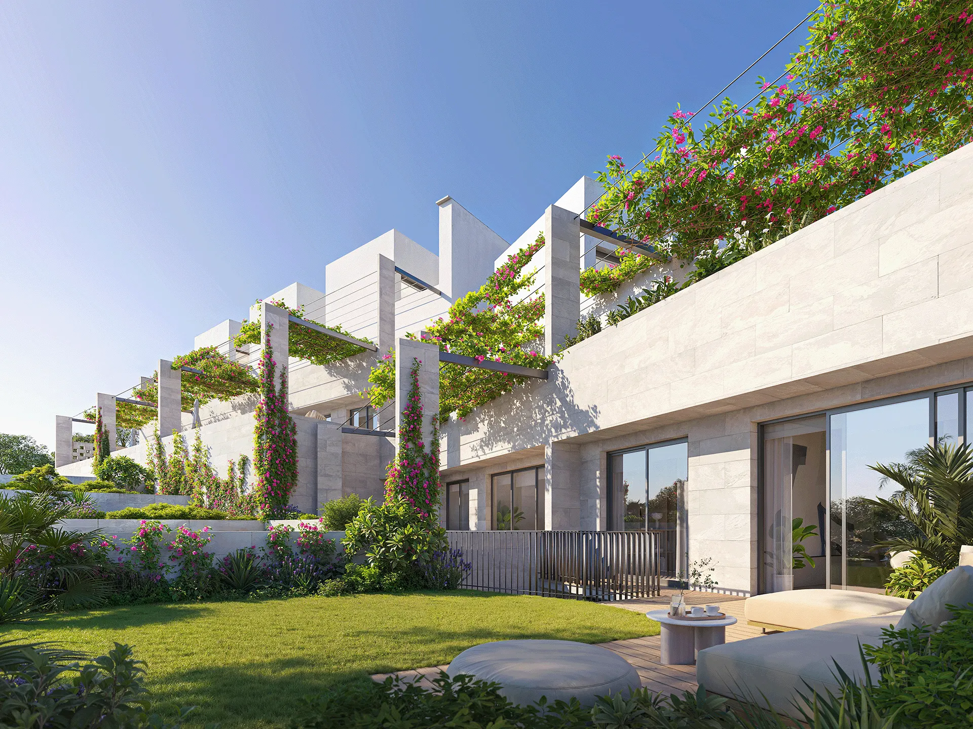 Modern terrace apartments with green plants, flowering vines, and outdoor seating on a sunny day.